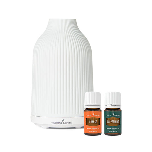 Adobe Mist Ultrasonic Diffuser van Young Living met keramische behuizing, ultrasone verneveling, LED-verlichting en meegeleverde Peppermint- en Orange-etherische olie.